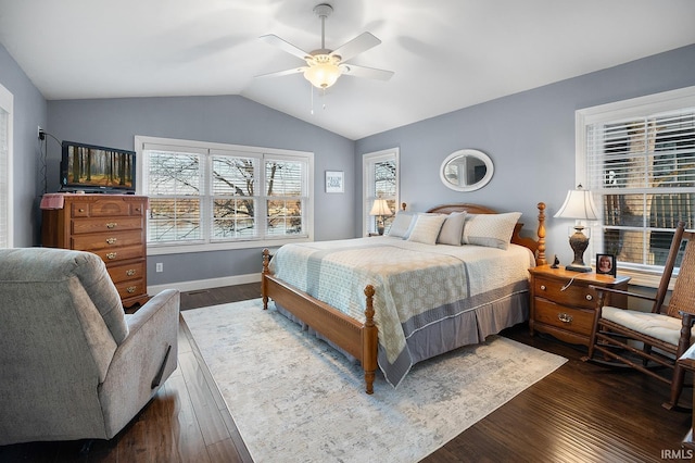 bedroom featuring vaulted ceiling, dark wood-style floors, baseboards, and ceiling fan