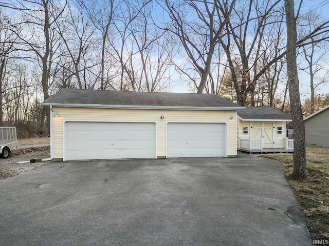 view of front of home featuring a detached garage and an outdoor structure