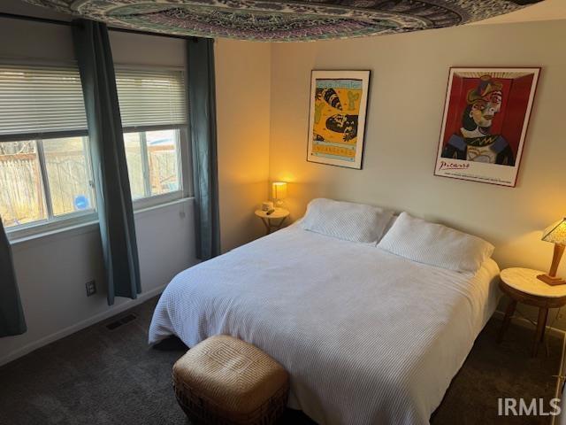 bedroom featuring visible vents, baseboards, and carpet floors