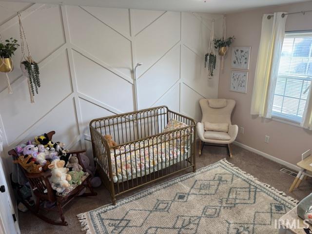 bedroom featuring visible vents, baseboards, and carpet