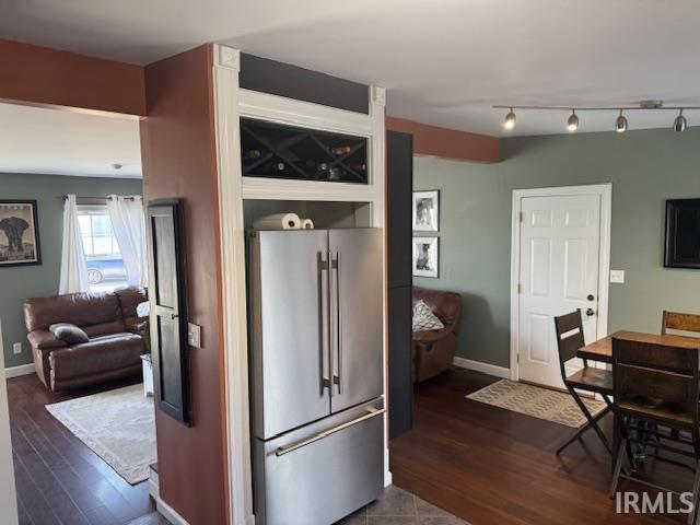 kitchen featuring dark wood-style floors, high end refrigerator, and baseboards