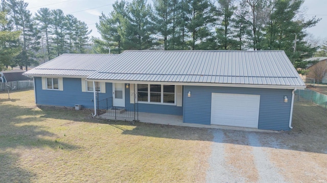 ranch-style house featuring a front yard, fence, covered porch, dirt driveway, and metal roof