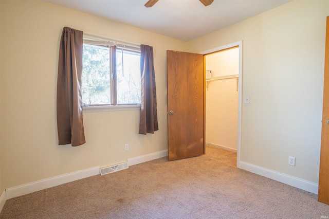 unfurnished bedroom with visible vents, baseboards, carpet, and a ceiling fan