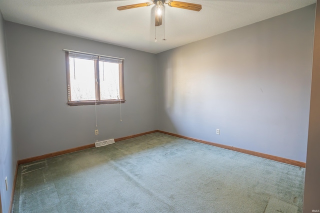 carpeted empty room featuring visible vents, baseboards, and a ceiling fan