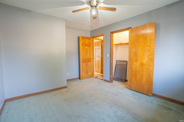 unfurnished bedroom featuring a ceiling fan, carpet, baseboards, and a closet