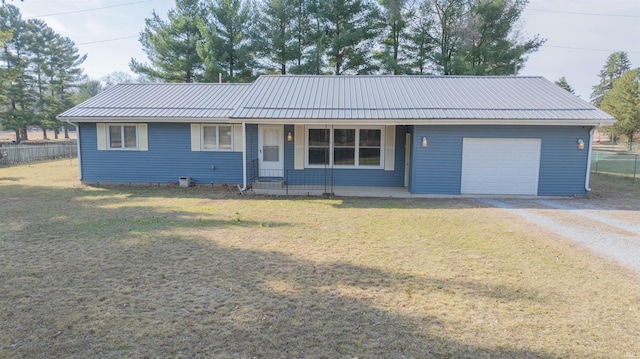 single story home with gravel driveway, a front lawn, fence, and a garage