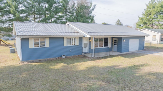 single story home with fence, a porch, a front yard, metal roof, and a garage