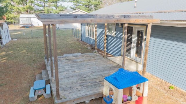 wooden deck featuring a yard and fence