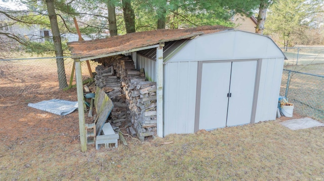 view of shed featuring fence