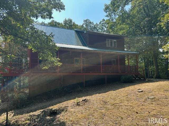 back of house with metal roof