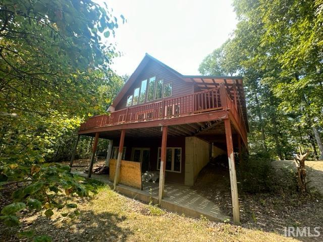 back of house with a wooden deck