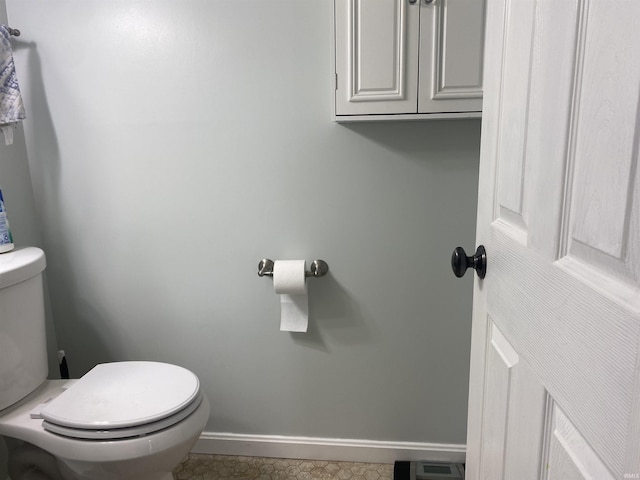 bathroom with toilet and baseboards