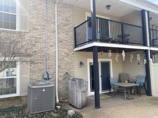 back of house with a patio, central air condition unit, and a balcony