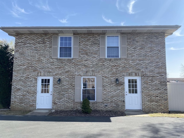 colonial inspired home featuring brick siding