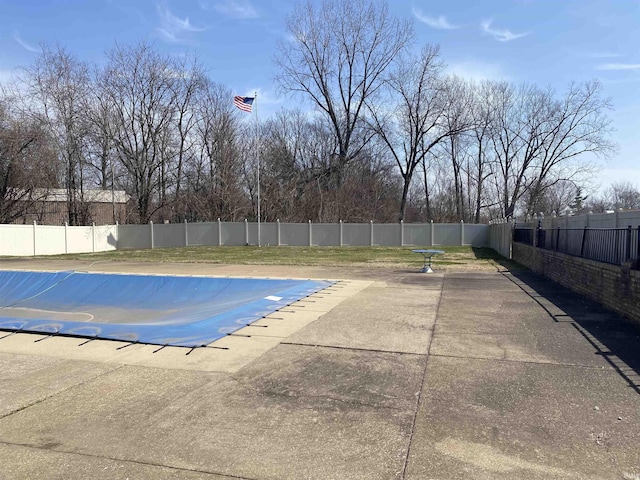 view of swimming pool featuring a patio, a fenced backyard, and a fenced in pool