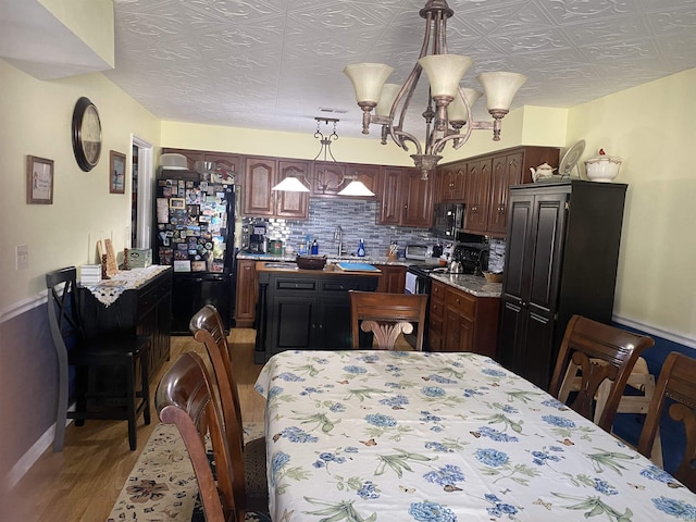 dining area with baseboards and wood finished floors