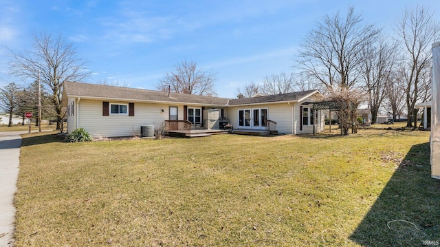 rear view of house with french doors, a lawn, and cooling unit