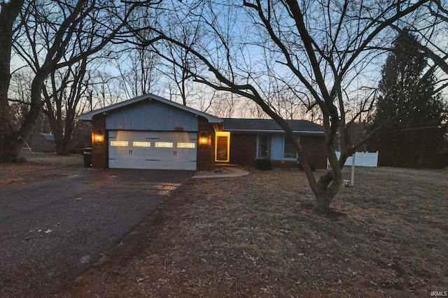 ranch-style house with an attached garage and driveway