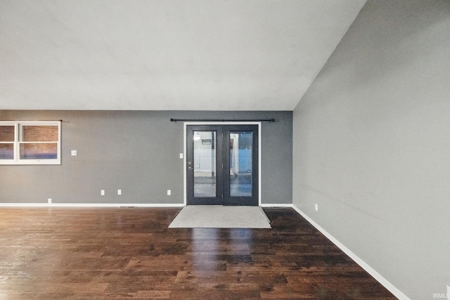 interior space featuring baseboards and wood finished floors