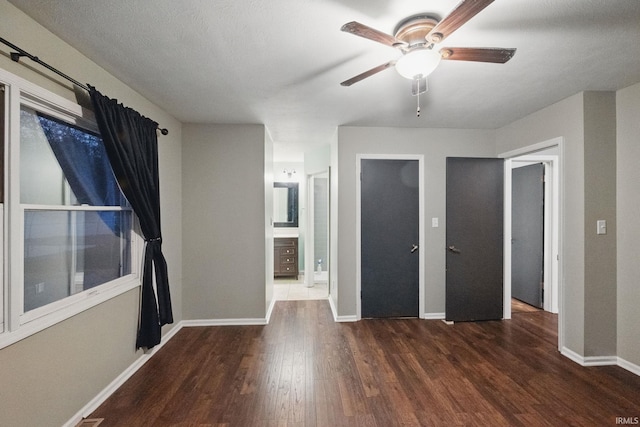 spare room featuring a ceiling fan, wood finished floors, and baseboards