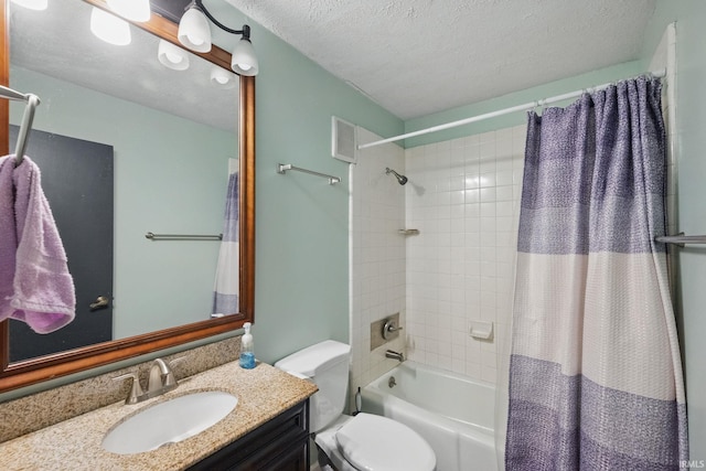 bathroom featuring vanity, toilet, shower / tub combo with curtain, and a textured ceiling