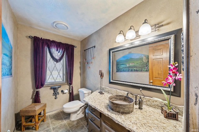 bathroom featuring toilet and vanity