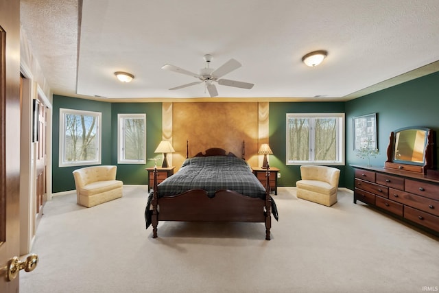 bedroom featuring baseboards, a textured ceiling, and carpet flooring