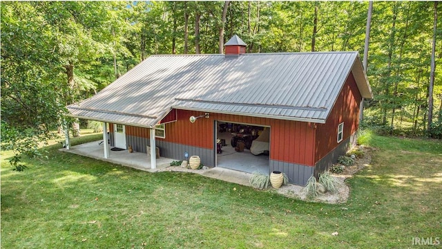 view of outbuilding with an outbuilding and a forest view