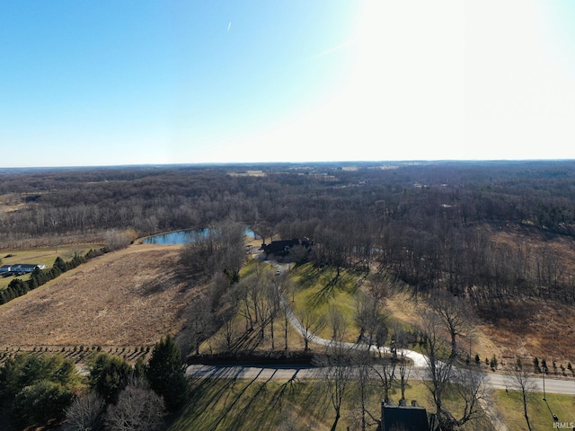 drone / aerial view featuring a forest view and a water view