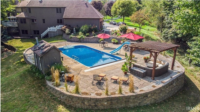 view of swimming pool with a water slide, stairs, a lawn, outdoor lounge area, and a patio