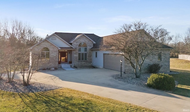 view of front facade with a garage, stone siding, concrete driveway, and a front yard