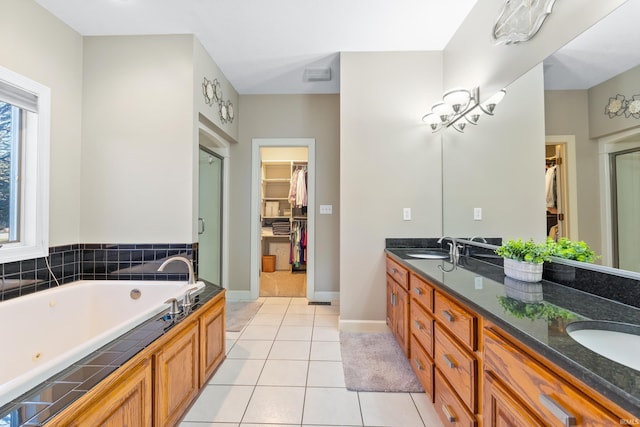 full bath featuring a stall shower, a sink, tile patterned flooring, double vanity, and a whirlpool tub