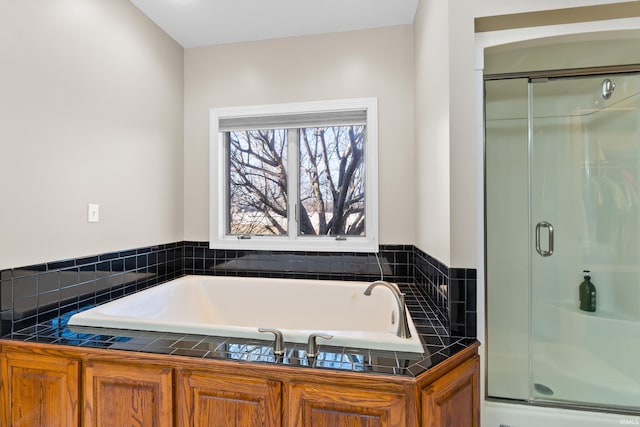 bathroom with a garden tub and a stall shower