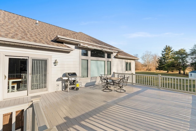 wooden deck featuring outdoor dining area and area for grilling