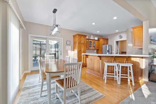 dining space with recessed lighting and light wood-type flooring