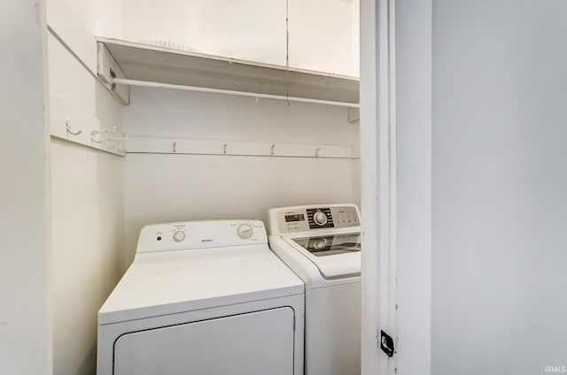 clothes washing area featuring laundry area and washer and clothes dryer