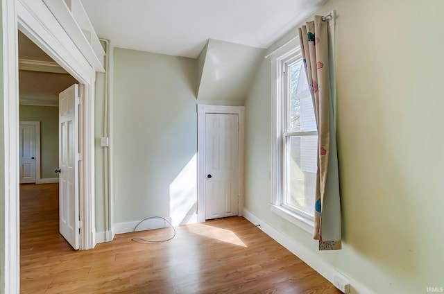 bonus room with light wood-style flooring and baseboards