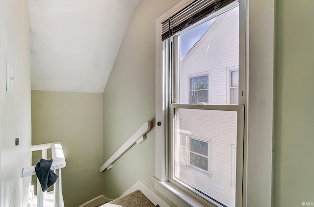 stairway featuring lofted ceiling