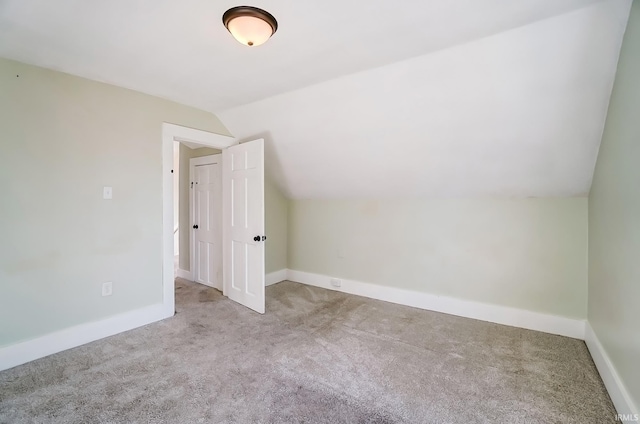 bonus room with baseboards, carpet, and vaulted ceiling