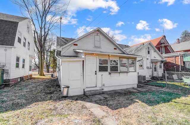 back of house featuring cooling unit and fence