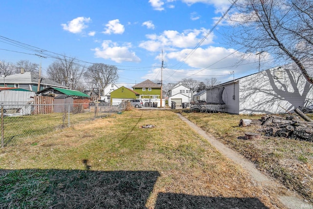 view of yard with fence and a garage