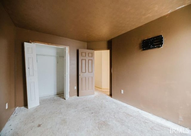 unfurnished bedroom with a closet and carpet floors