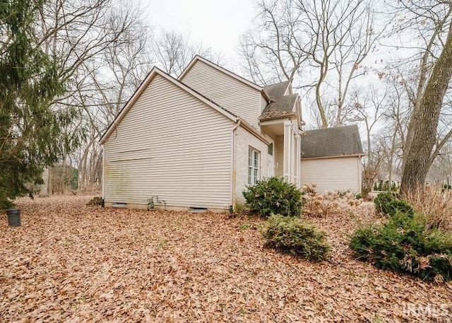 view of side of home featuring crawl space