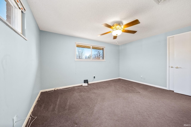 carpeted empty room featuring a textured ceiling, baseboards, and ceiling fan