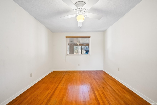 unfurnished room with light wood-style flooring, a textured ceiling, baseboards, and ceiling fan