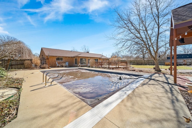 view of swimming pool with a patio and a fenced backyard