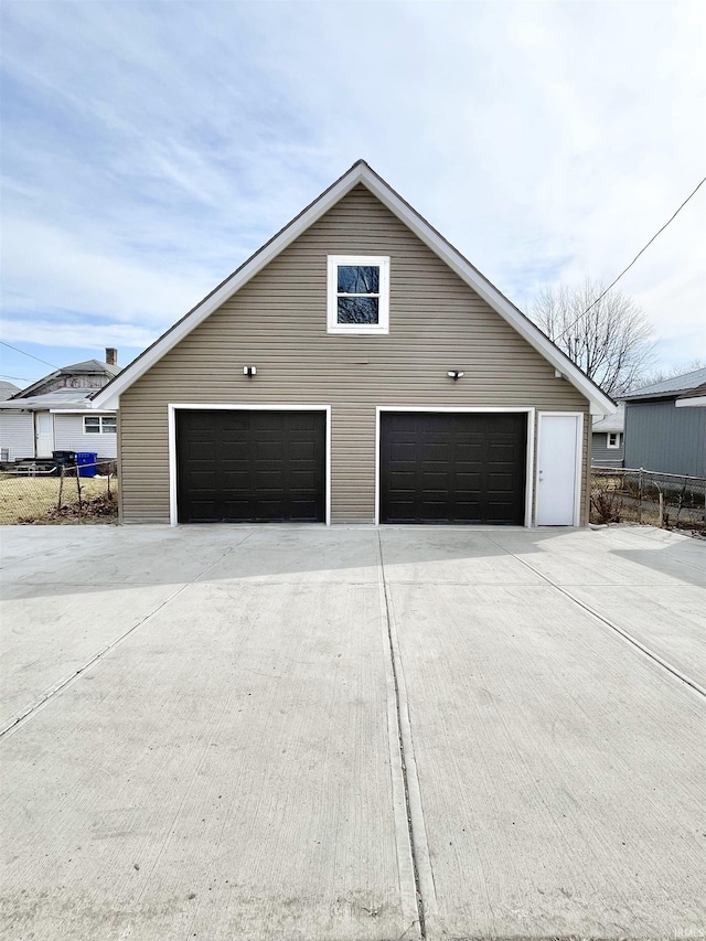 detached garage featuring fence