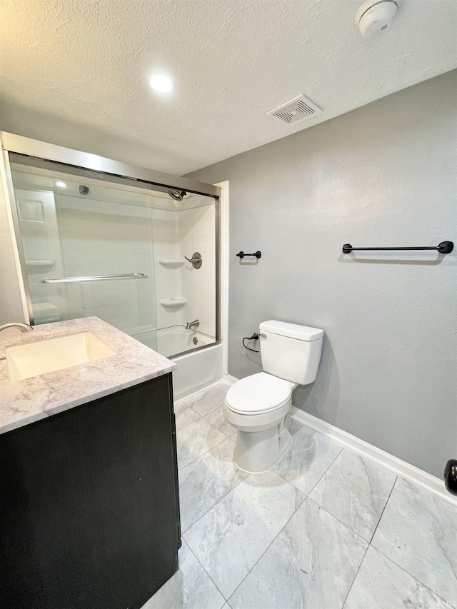 bathroom featuring visible vents, toilet, a textured ceiling, bath / shower combo with glass door, and vanity