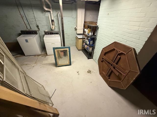 unfinished basement with washing machine and clothes dryer