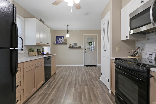 kitchen featuring backsplash, light countertops, light wood-style floors, black appliances, and a ceiling fan